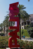 Spain, Balearic Islands, Majorca, Palma de Mallorca. Escultura Palma. Red Palma sign on the Paseo Sagrera or Passeig de Sagrera in Catalan, a quiet promenade on the seafront.