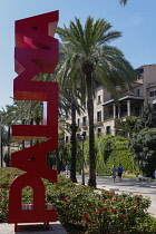 Spain, Balearic Islands, Majorca, Palma de Mallorca. Escultura Palma. Red Palma sign on the Paseo Sagrera or Passeig de Sagrera in Catalan, a quiet promenade on the seafront.