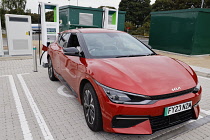 Transport, Road, Car, Electric vehicle charging point with car plugged in to charge.