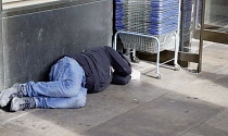 England, London, Homeless mans sleeping in door of supermarket.