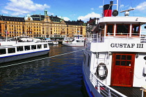 Sweden, Stockholm, Sightseeing cruise boat with The Grand Hotel beyond.