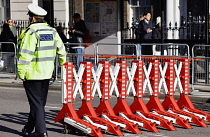 England, London, Whitehall, Police traffic barrier and police officer.