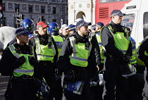 England, London, Parliament Square, Riot police and public order police contain a group of right wing supporters. Red cap officer unit commander, white cap seargent.
