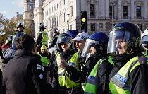 England, London, Parliament Square, Riot police and public order police contain a group of right wing supporters. Red cap officer unit commander, white cap seargent.