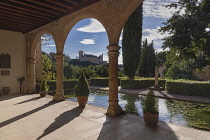 Spain, Castile, Segovia, Monasterio de Santa María del Parral, founded by King Henry IV of Castile in the 1450's, cloister with the Alcazar in the background .