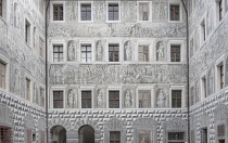 Austria, Innsbruck, Schloss Ambras which is a 16th century Renaissance castle, The Old Castle, Grisaille or grey relief al fresco painting on the wall of the Inner Courtyard representing princely virt...