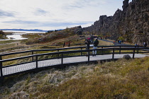 Iceland, Golden Circle, Thingvellir National Park in Autumn colours. The Mid-Atlantic Rift between the North American and Eurasian tectonic plates. Almannagja Gorge marking the edge of the North Ameri...