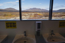 Iceland, Golden Circle, Thingvellir National Park in Autumn colours. The Mid-Atlantic Rift between the North American and Eurasian tectonic plates. View from public toilets.