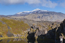 Iceland, Snaefellsnes Peninsula National Park, Snaefellsjokull, a 700,000-year-old glacier-capped stratovolcano with moss covered lava field in the foreground.