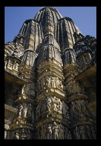 India, Madhya Pradesh, Khajuraho, View looking up at Temple columns covered in erotic carvings.