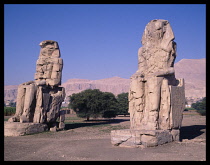 Egypt, Thebes, The Colossi of Memnon. Two faceless 60ft tall enthroned statues of Amenhotep III.