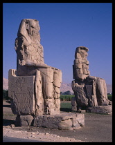 Egypt, Thebes, Colossi of Memnon. Two faceless 60ft tall enthroned statues of Amenhotep III.