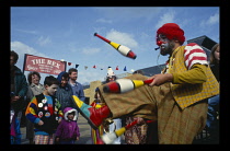 England, West Sussex, Bognor Regis, Juggling Clown at the Bognor Clown Convention with onlookers.