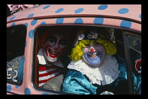 Entertainment, Clowns, Two clowns sitting in a pink and blue spotted car at the Bognor Regis Clown Convention.