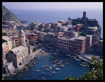 Italy, Liguria, Cinque Terre, Vernazza. View over harbour and surrounding architecture.