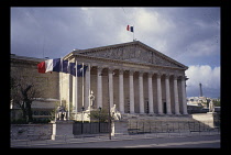 France, Ile de France, Paris, Palais-Bourbon housing the French National Assembly.  Colonnaded exterior with portico and statues.