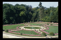 France, Indre-et-Loire, Chenonceaux, Formal gardens with pink flowerbeds surrounding circular fountains.