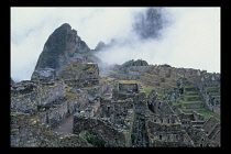 Peru, Cusco Department, Machu Picchu, Partial view over the ruins  Huanya Picchu mountain peak in background.
