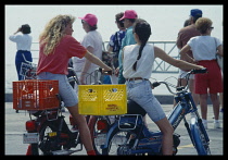 USA, Florida, Key West, Young girls on mopeds.