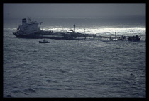 Wales, Dyfed, Environment, Oil tanker the Sea Empress aground and abandoned off St Anns Head with pilot boat on standby.