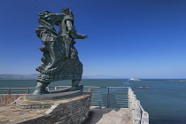 Ireland, County Kerry, Fenit, Bronze sculpture of St Brendan the Navigator by Tighe O Donoghue on Samphire Rock in the harbour.