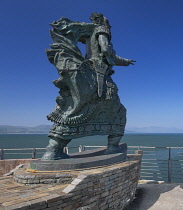 Ireland, County Kerry, Fenit, Bronze sculpture of St Brendan the Navigator by Tighe O Donoghue on Samphire Rock in the harbour.