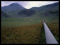 Scotland, Highlands, Rannoch, Railway station in moorland area with roof  platform  railway tracks and surrounding countryside under thick layer of snow.