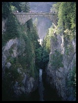 Italy, Lombardy, Stelvio National Park, Stelvio Pass. Hairpin road leading down a hillside witha bus on a sharp bend.