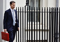 England, London, Westminster, Jeremy Hunt, Conservative Chancellor of the Exchequer, holding the red despatch box on Downing Street  during budget day 2024.