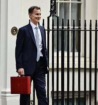 England, London, Westminster, Jeremy Hunt, Conservative Chancellor of the Exchequer, holding the red despatch box on Downing Street  during budget day 2024.