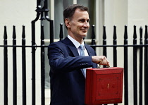 England, London, Westminster, Jeremy Hunt, Conservative Chancellor of the Exchequer, holding the red despatch box on Downing Street  during budget day 2024.