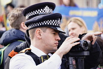 England, London, Police recording Ukraine demonstration in Trafalgar Square.