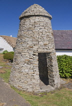 Republic of Ireland, County Donegal, Glencolmcille Folk Village also known as Father McDyers Folk Village, reconstruction of an ancient Irish clochan or beehive hut which is a dry-stone hut with a cor...
