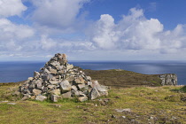 Republic of Ireland, County Donegal, Horn Head near Dunfanaghy with a mini cairn in the foreground and the Atlantic Ocean in the background.