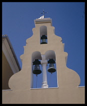 Greece, Ionian Islands, Corfu, Paleokastritsa. Monastery detail of bells and spire.