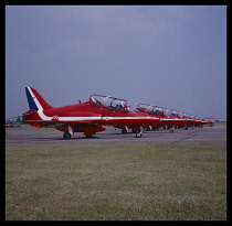 Transport, Air Travel, Formation Flying, Red Arrow planes stationary and in a row on the runway.