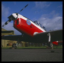 Transport, Air Travel, Private Planes, Chipmunk T10. Stationary red and white painted plane viewed from a low angle.