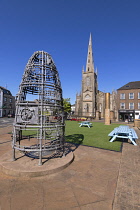 Republic of Ireland, County Monaghan, Monaghan town, Church Square, St Patrick's Church of Ireland with the Hive of Knowledge created by master blacksmiths in 2011 in the foreground.