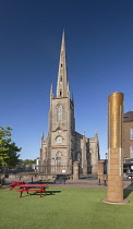 Republic of Ireland, County Monaghan, Monaghan town, Church Square, St Patrick's Church of Ireland with the Monaghan Memorial which is a sandstone and metal pillar erected in front of the courthouse i...