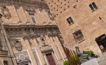 Spain, Castile and Leon, Salamanca, the monument to Spanish music theorist and organist Francisco de Salinas with La Clerecía Church and Casa de las Conchas behind.