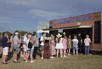England, Surrey, Guildford, Guilfest, Queue of festival goers at fast food stall.