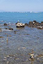 France, Provence-Alpes-Cote d'Azur, Antibes, Rock balanced stacks in shallow water.