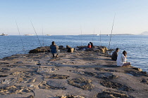 France, Provence-Alpes-Cote d'Azur, Antibes, Juan-les-Pins, People fishing from jetty.