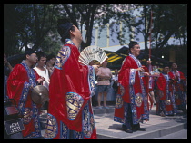 Singapore, Religion, Men in costumes leading funeral .