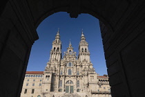 Spain, Galicia, Santiago de Compostela, the Cathedral of Santiago de Compostela seen through an arch in Plaza del Obradoiro.