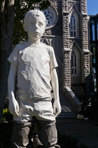 Canada, Quebec Province, Quebec City, Vieux Quebec, Old Quebec City Upper Town, Teddy Bears (2023) by German artist Willy Verginer depicting a young boy kneeling on teddy bears.