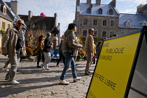 Canada, Quebec Province, Quebec City, Place Royale in Old Quebec City, Vieux Quebec in Basse-Ville or Lower Town. Pedestrians walk past The Quebec Art Gallery. One of the inflatable Mr Pink, or Monsie...