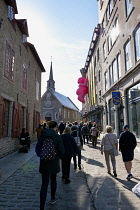 Canada, Quebec Province, Quebec City, Pedestrianswith long shadows walking towards Place Royale in Old Quebec City, Vieux Quebec in Basse-Ville or Lower Town.