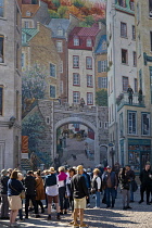 Canada, Quebec Province, Quebec City, Old Quebec City, Vieux Quebec in Basse-Ville or Lower Town. The immense Fresque des Québécois on Côte de la Montagne with sightseers. The mural recounts the st...
