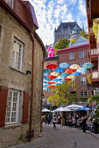 Canada, Quebec Province, Quebec City, Old Quebec City, Vieux Quebec. Chateau Frontenac with the iconic umbrellas on rue du Cul-de-Sac in the Quartier Petit Champlain in Basse-Ville, or Lower Town. One...
